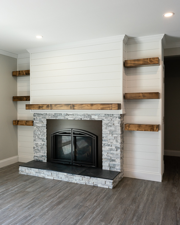 A newly remodeled stone and shiplap fireplace