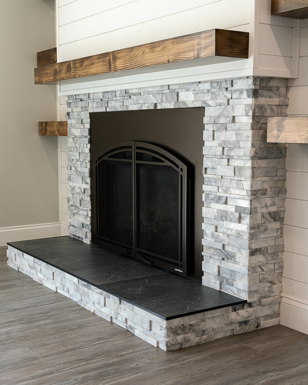 marble stone and shiplap fireplace