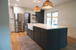 a dark blue kitchen island with sink