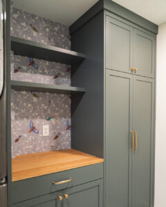 new dark green laundry room cabinetry